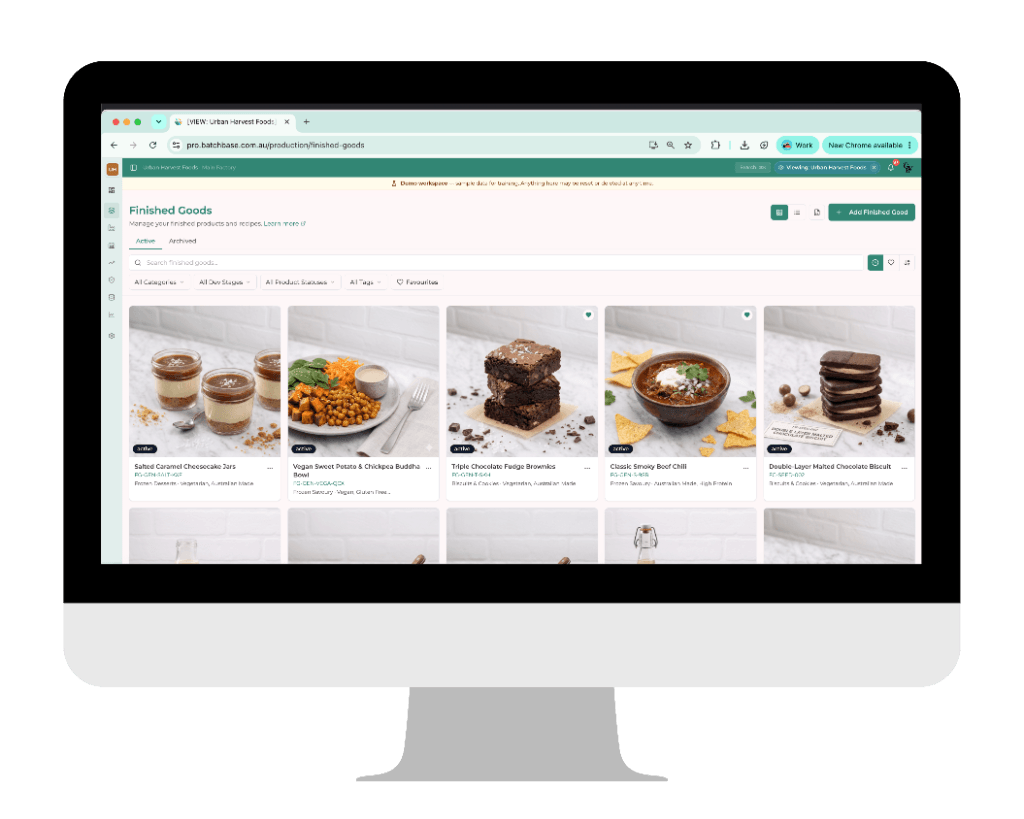 Batchbase finished goods product hub showing food product cards with photos and details inside a modern iMac mockup display